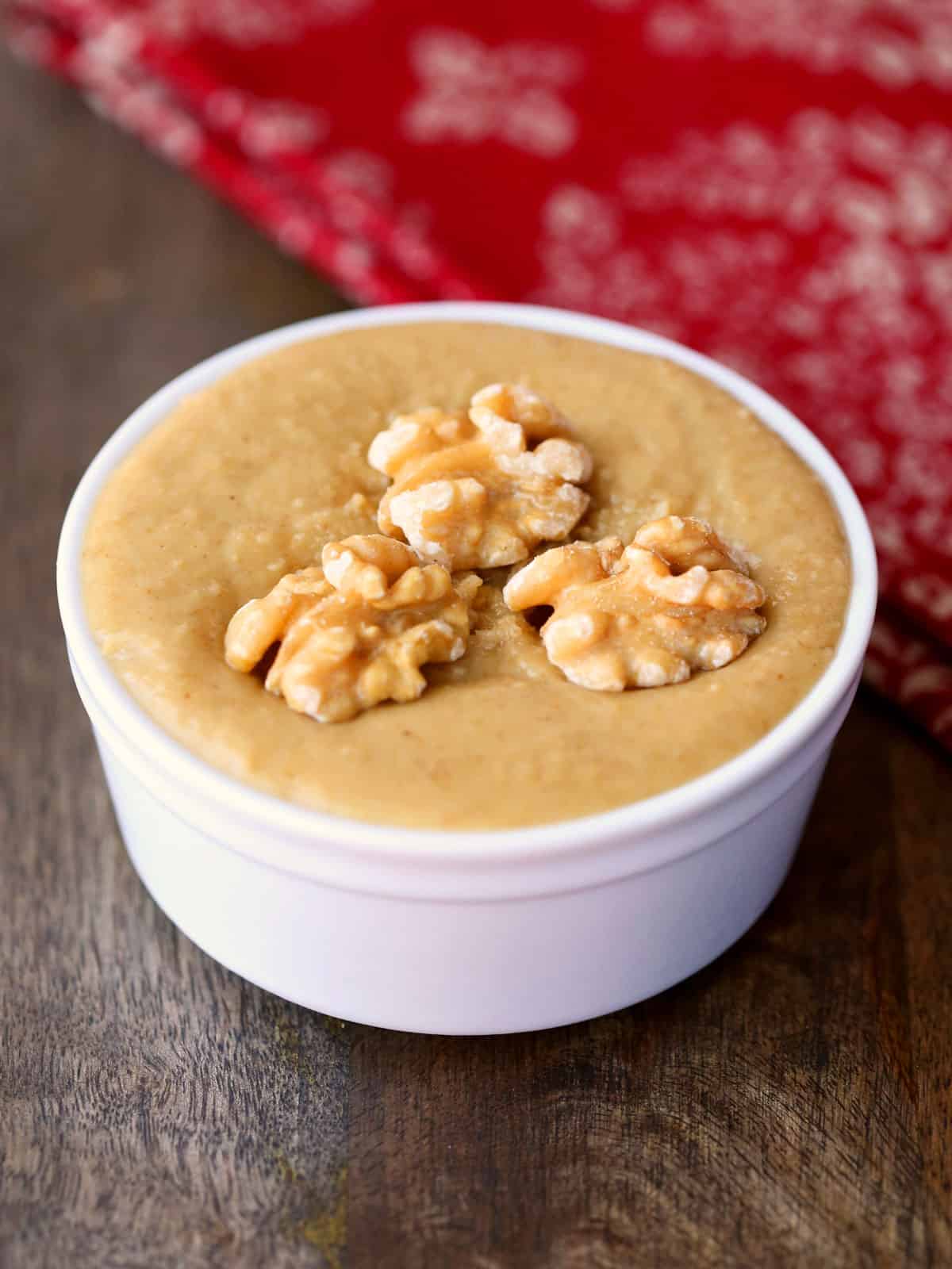 Walnut butter is served in a white bowl.