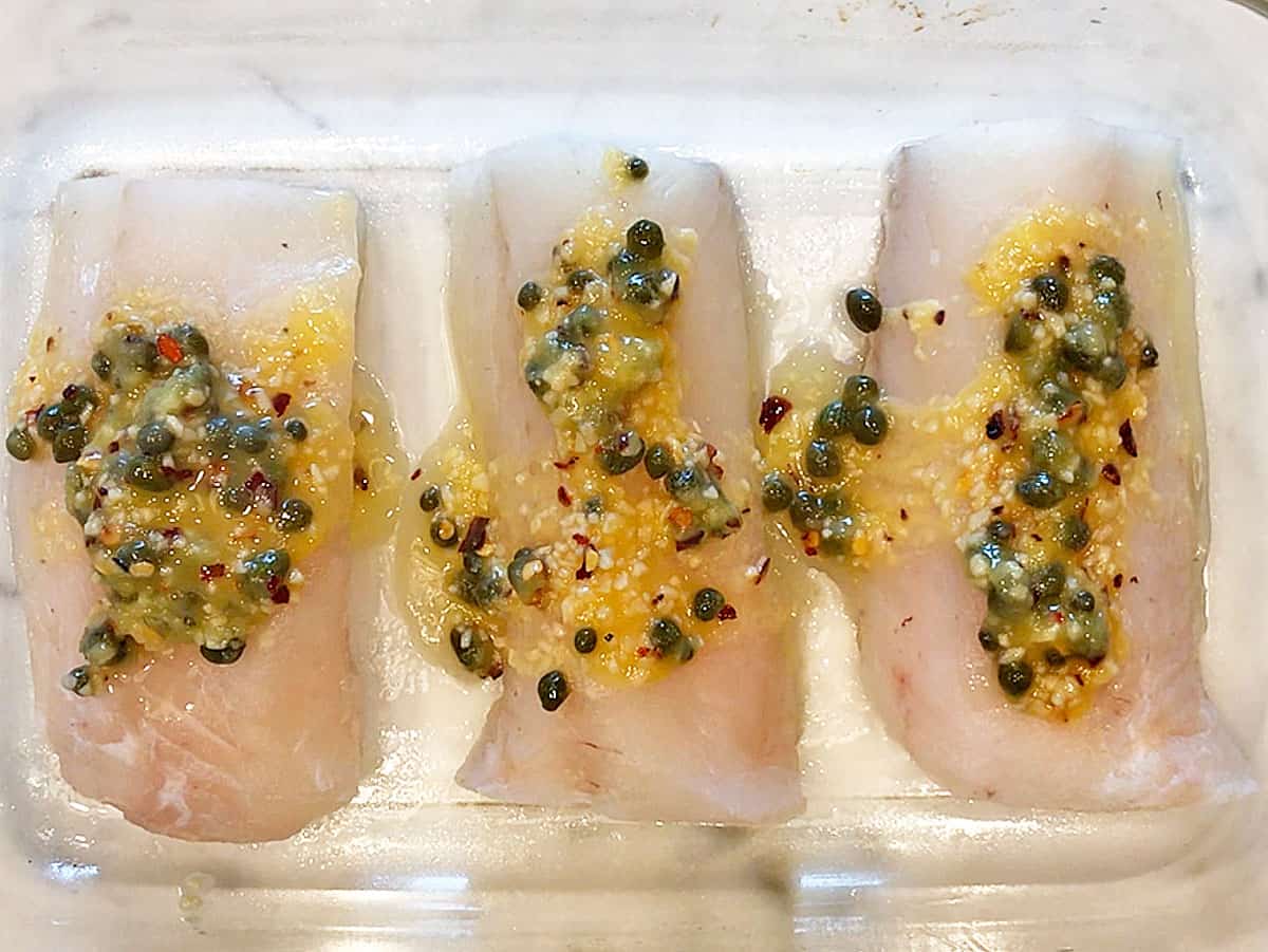 The cod fillets are coated with the sauce.