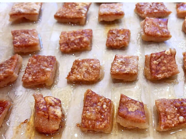 The pork rinds are ready on the baking sheet.