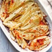 Roasted fennel is served in a baking dish.