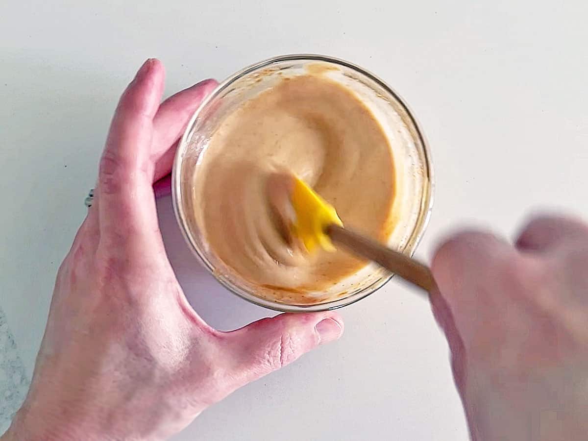 Mixing the dip in a small bowl.