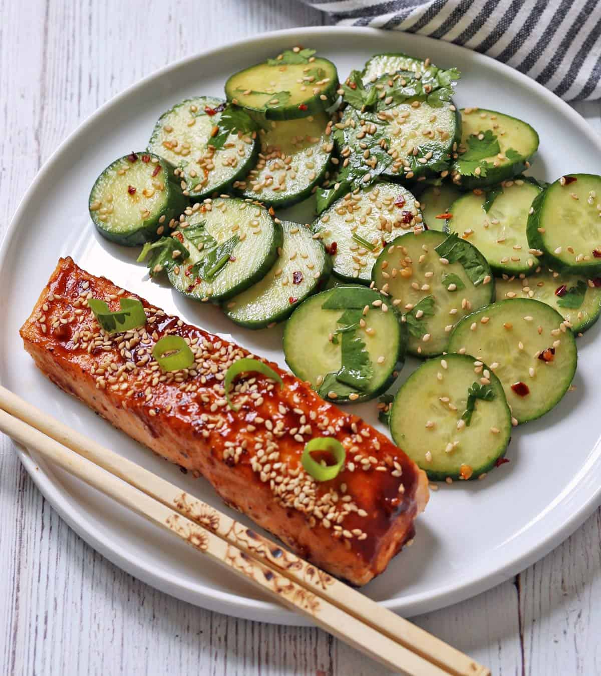 A fillet of Asian salmon is served with Asian cucumber salad.