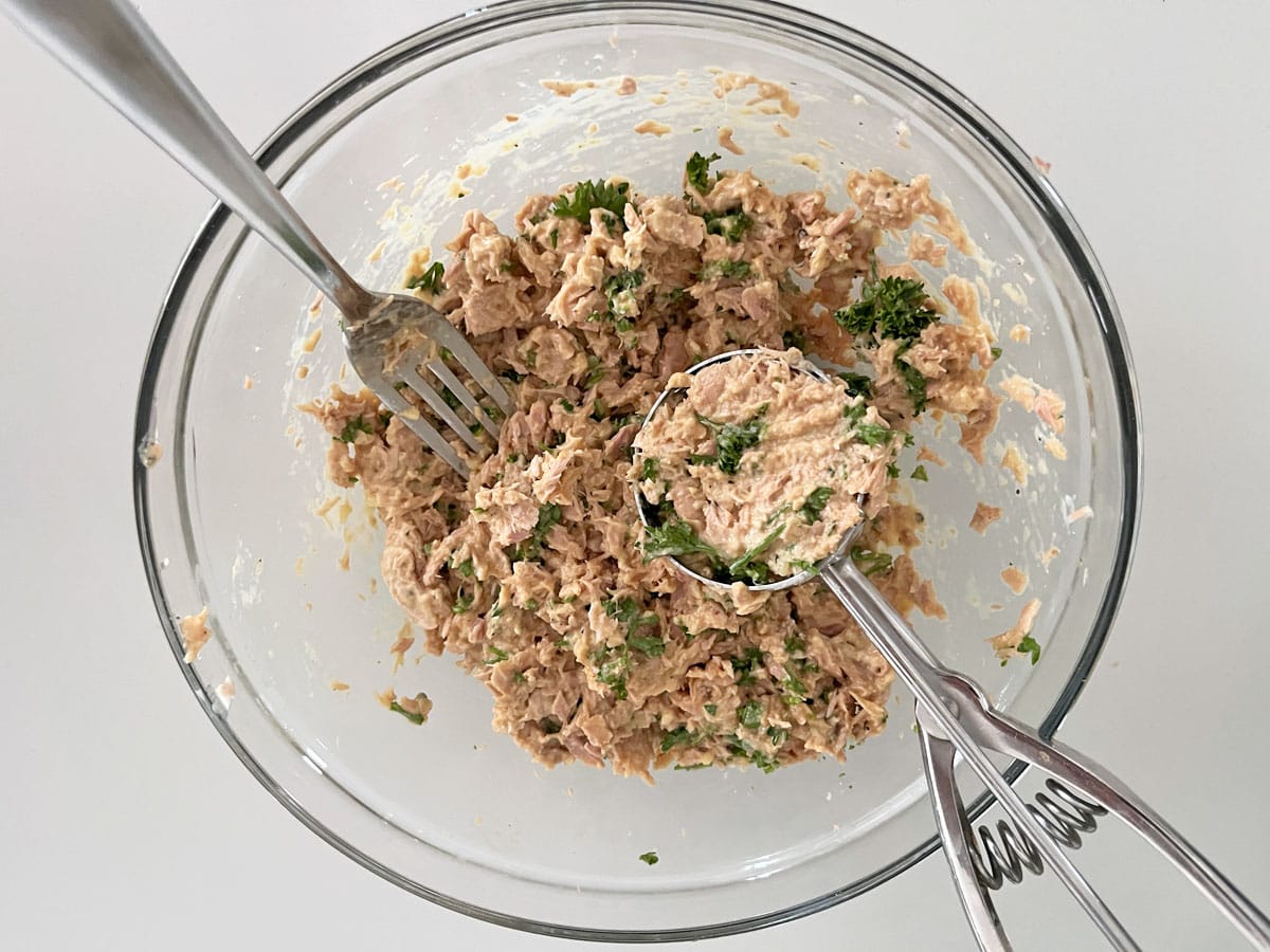 Packing the tuna mixture into the scoop.