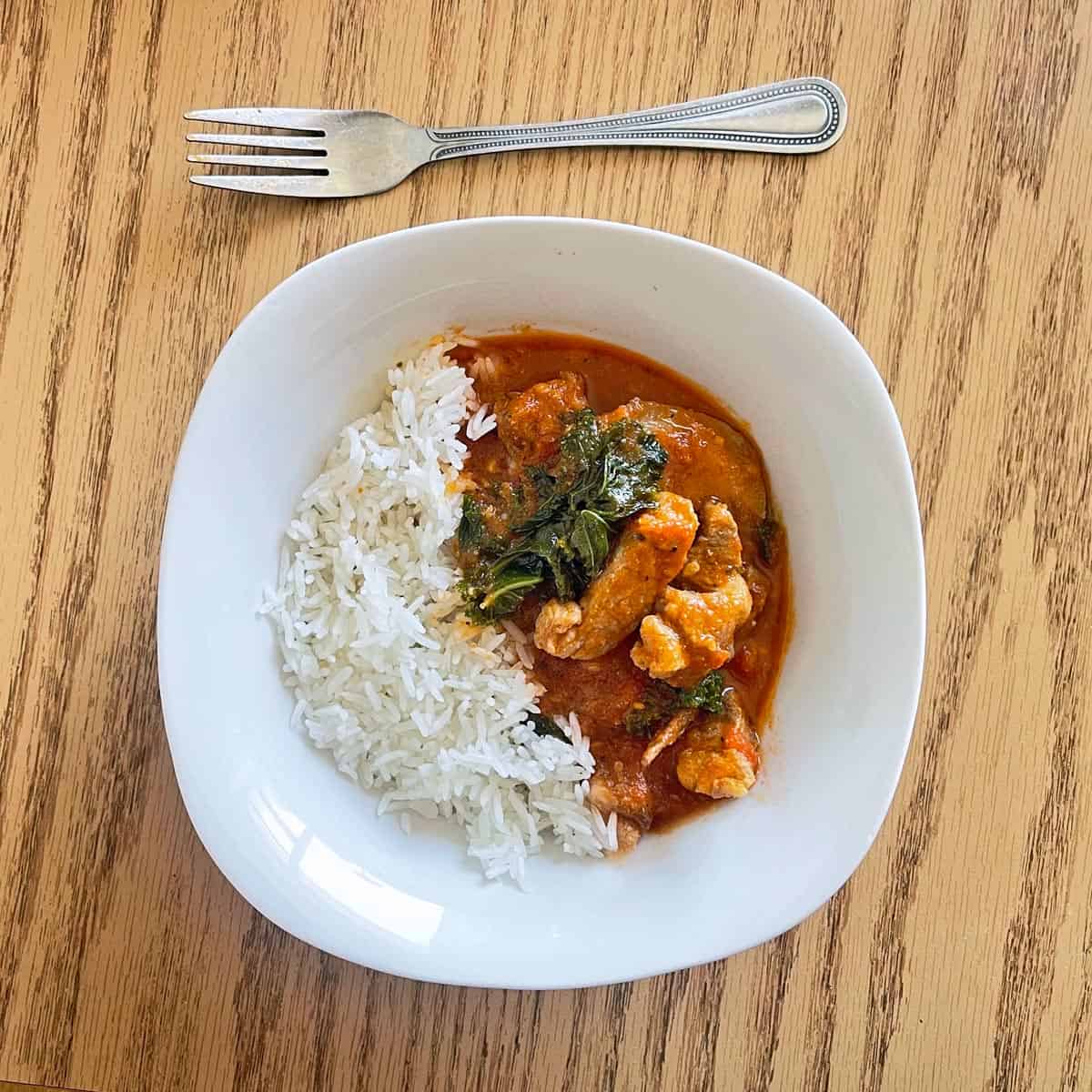 Pork stew is served with rice.