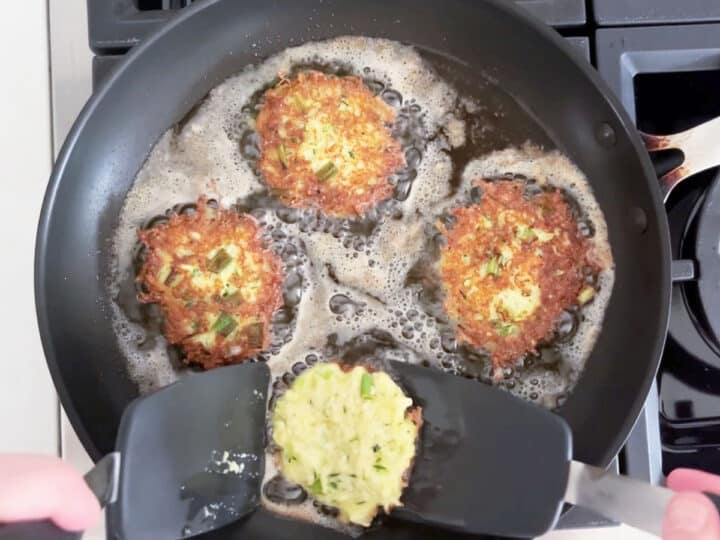 Frying the fritters in a skillet.