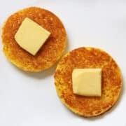 Two pieces of 90 second bread are topped with butter.