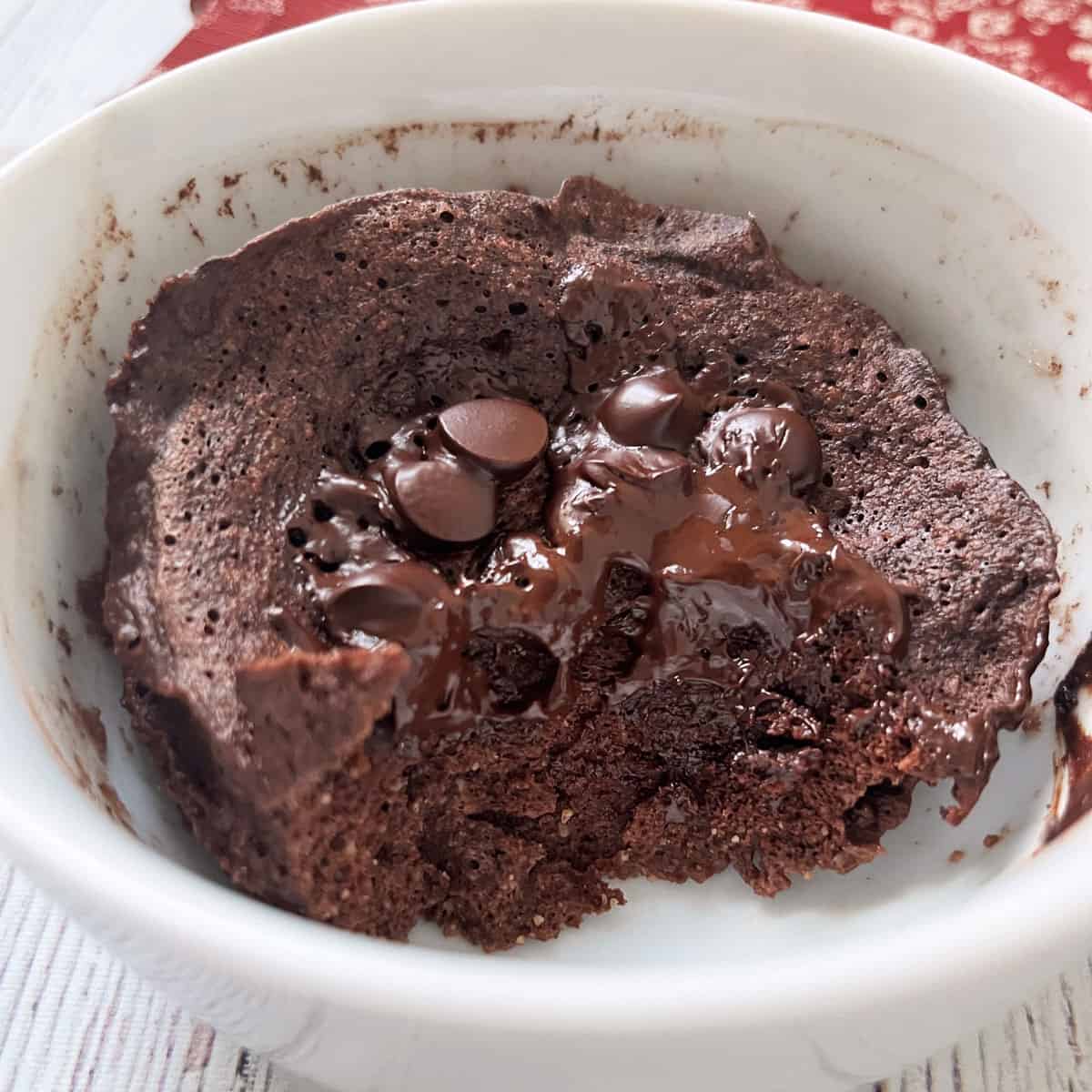 A half-eaten almond flour chocolate mug cake.