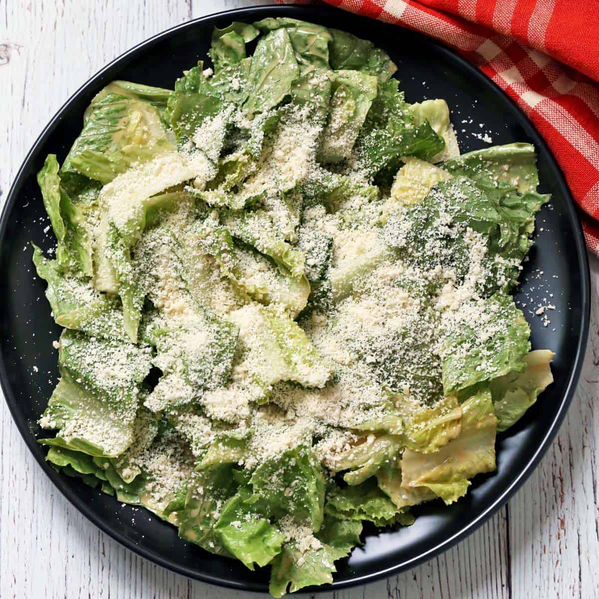 Caesar salad is topped with grated Parmesan.