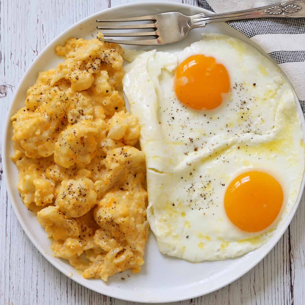 Cauliflower mac and cheese is served with eggs.
