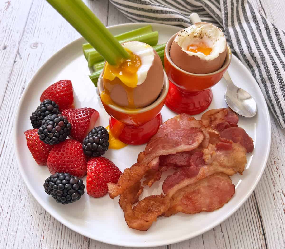 Celery is dipped into a soft-boiled egg.