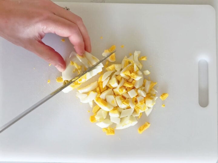 Chopping the eggs.