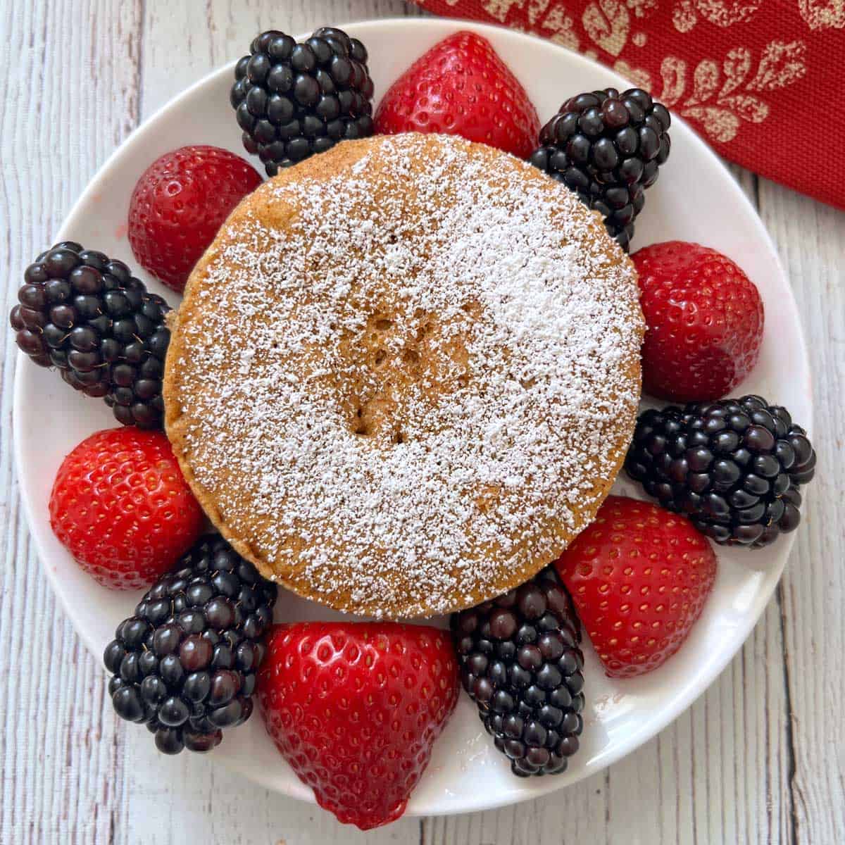 Keto mug cake is served with berries.