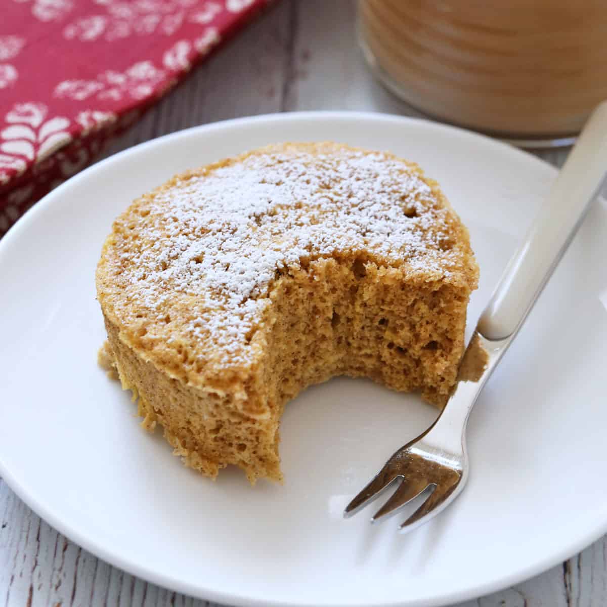 Keto mug cake is served with coffee.