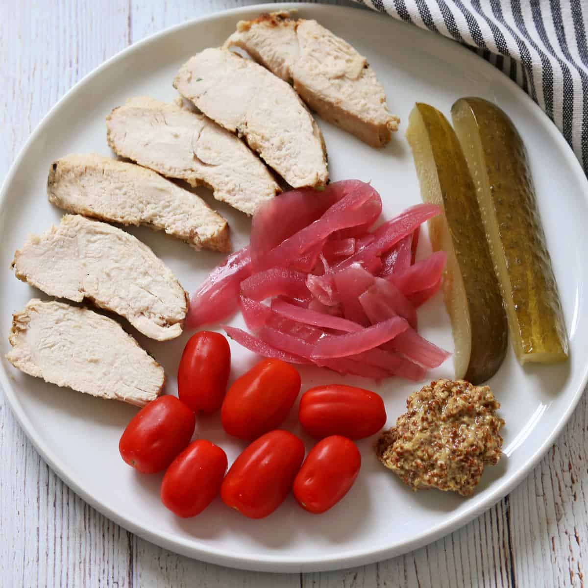 Pickled red onions are served with leftover chicken.