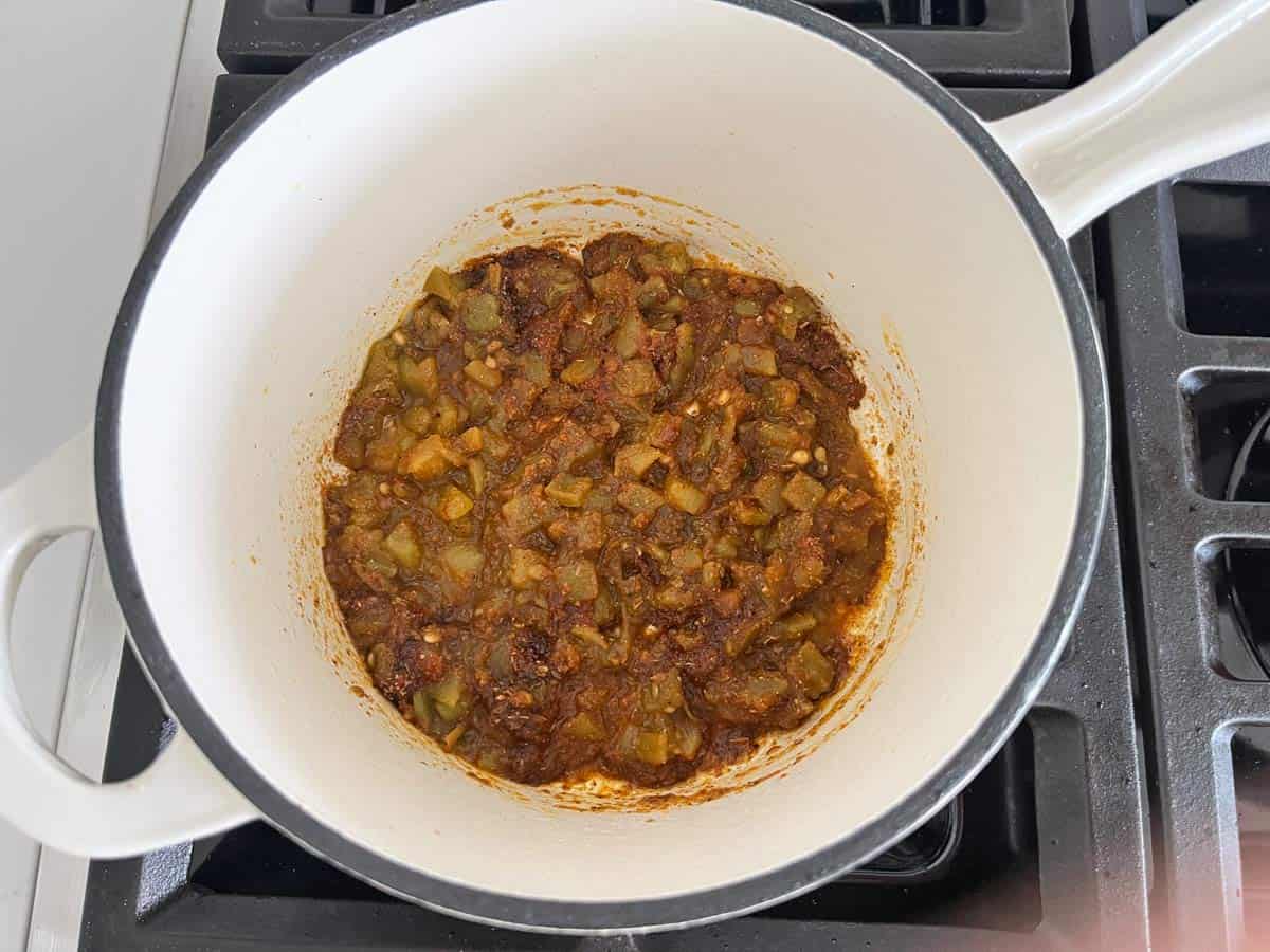 Cooking chiles and spices in olive oil.