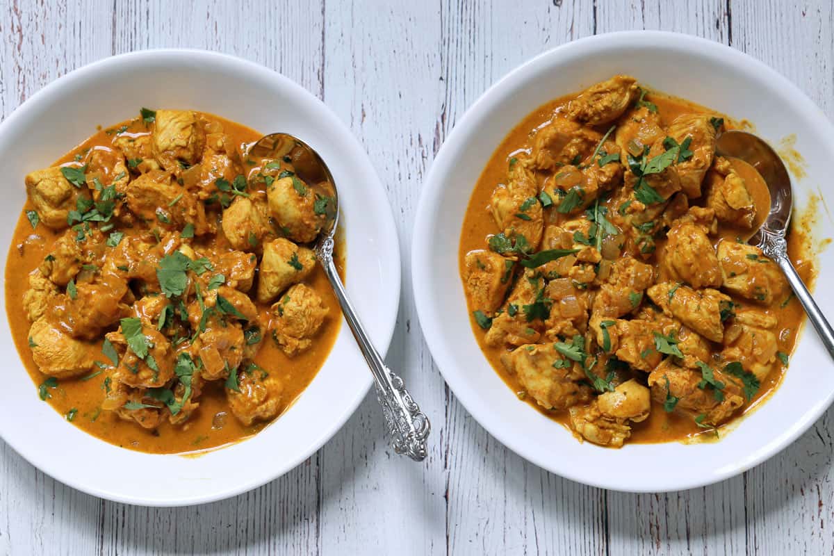 Two bowls of Thai chicken curry.