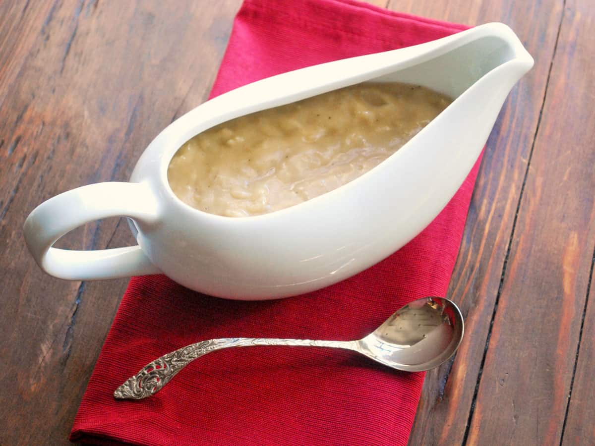 Chunky gravy is served in a gravy boat.
