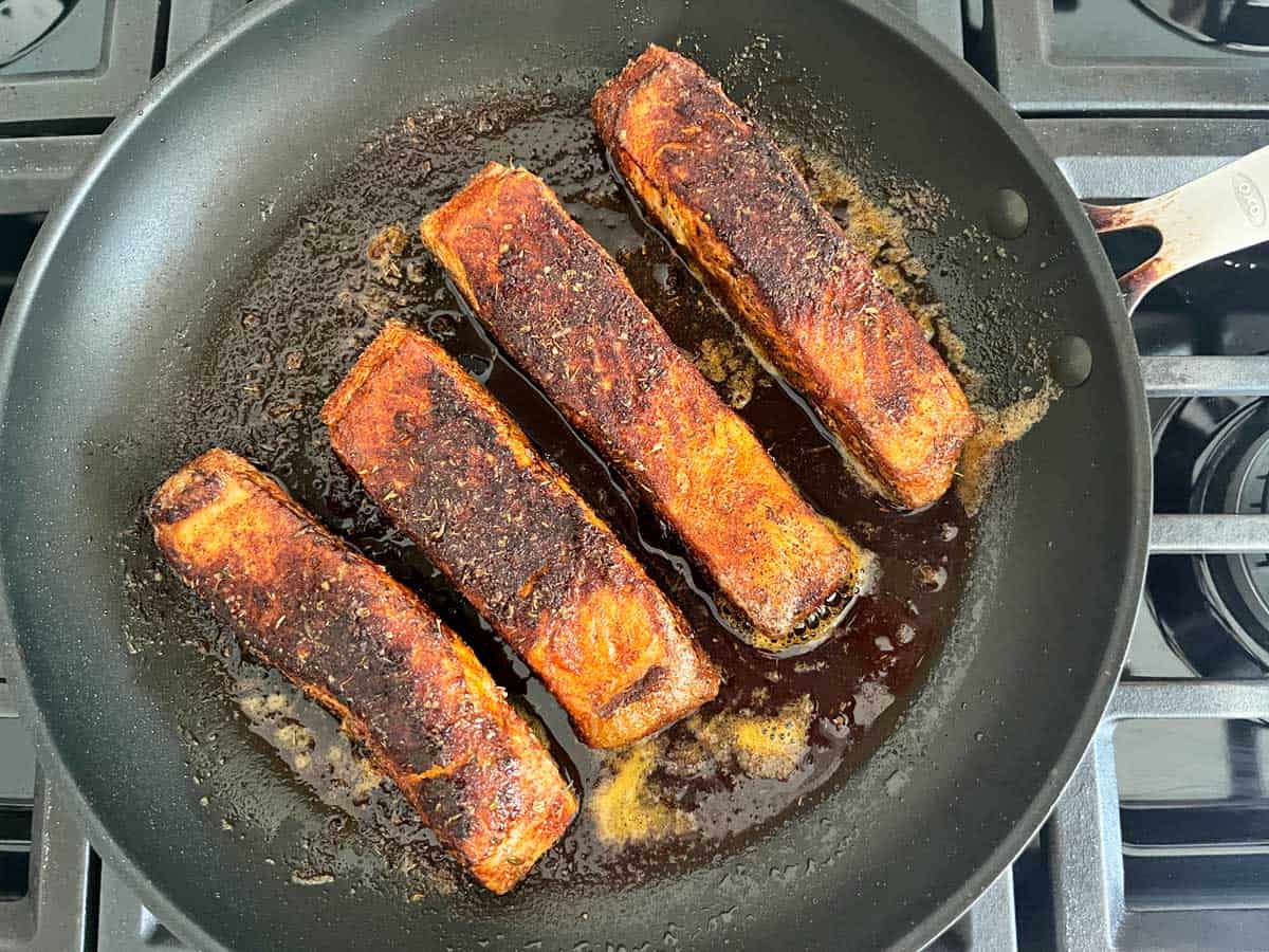 Blackening salmon in an oven-safe nonstick skillet.
