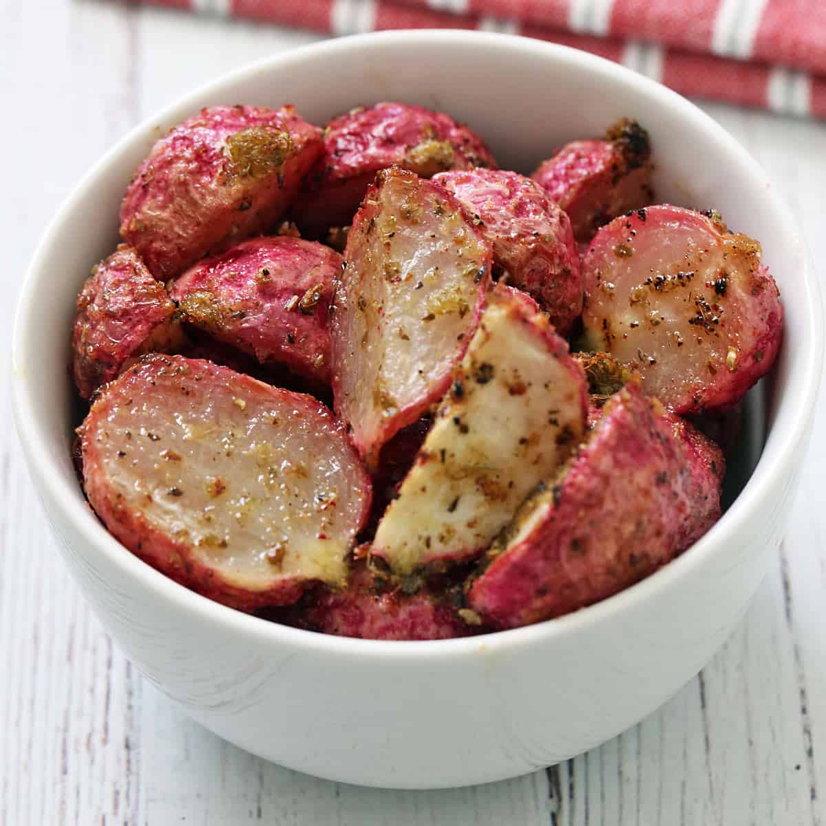 Roasted radishes seasoned with olive oil, salt, garlic powder, onion powder, oregano, and cumin.
