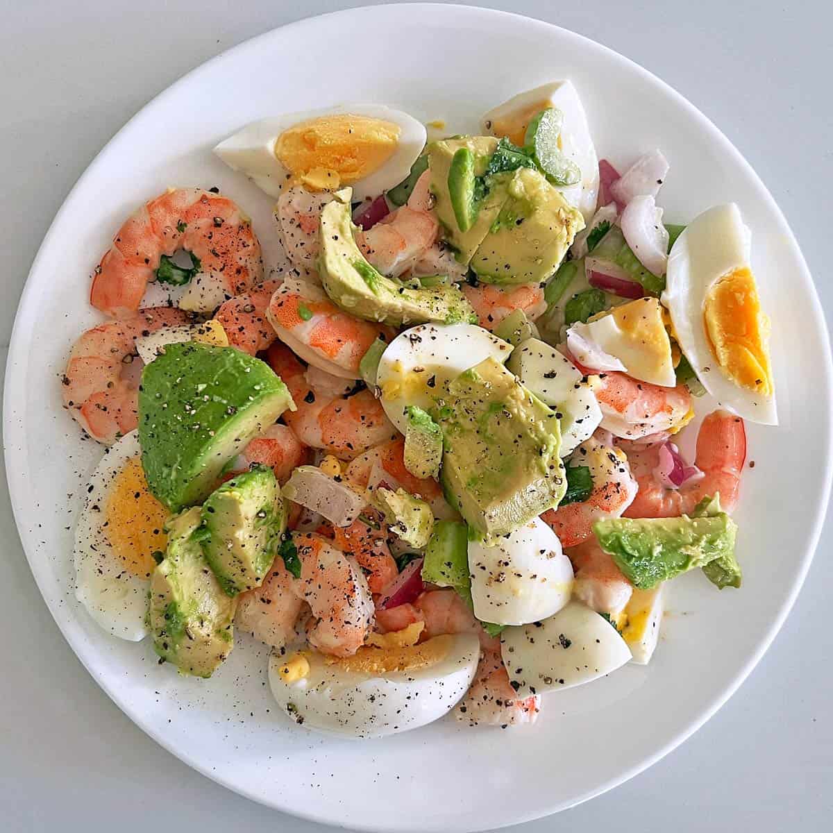 Eggs and avocado were added to a shrimp salad.