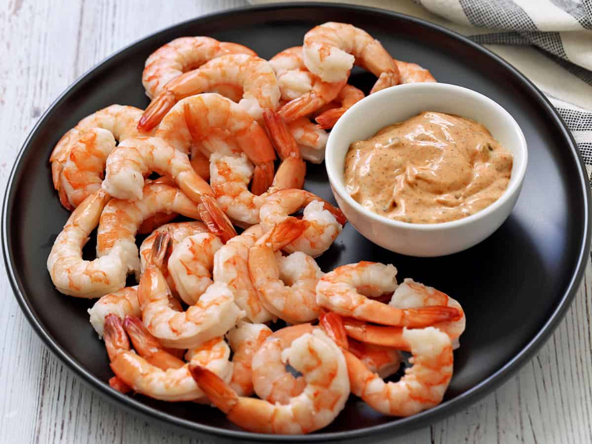 Smoked paprika tartar sauce is served as a dipping sauce for shrimp.
