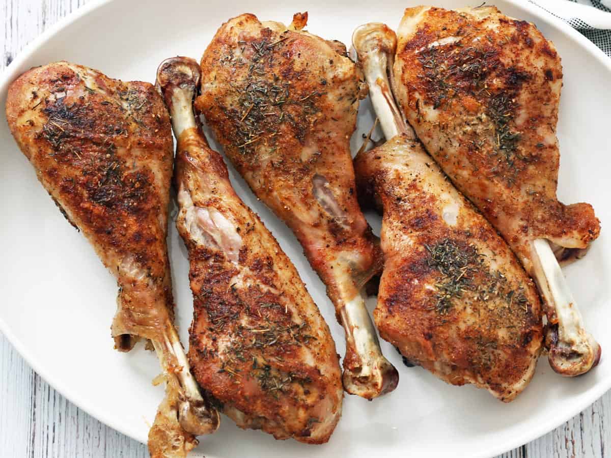 Turkey legs on a white platter.