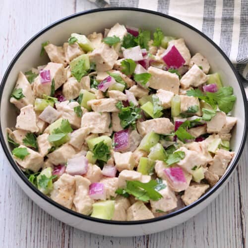 Turkey salad is served in a white bowl.