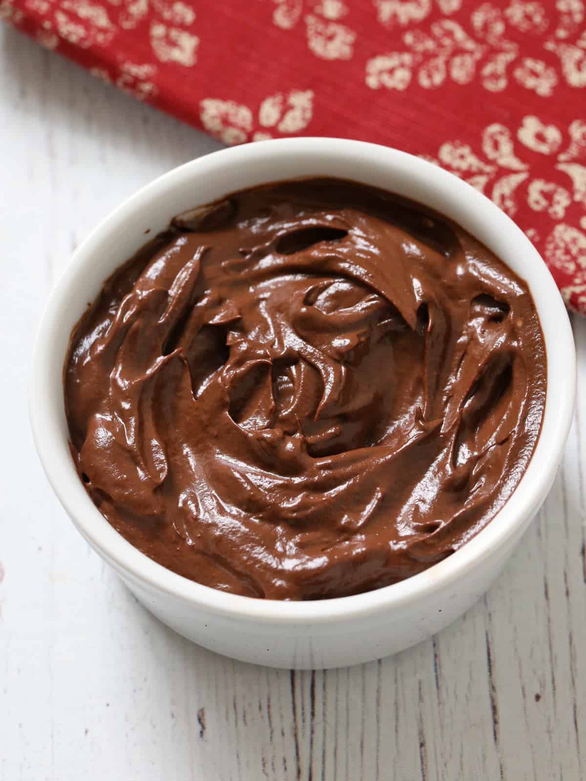 Avocado chocolate mousse is served in a white bowl.