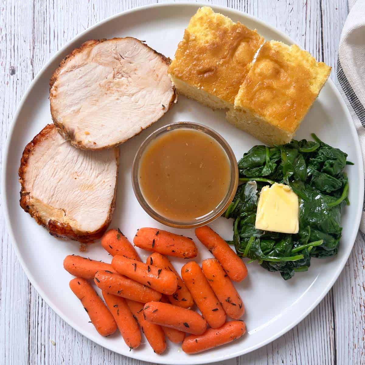 Two pieces of cornbread on a Thanksgiving plate.