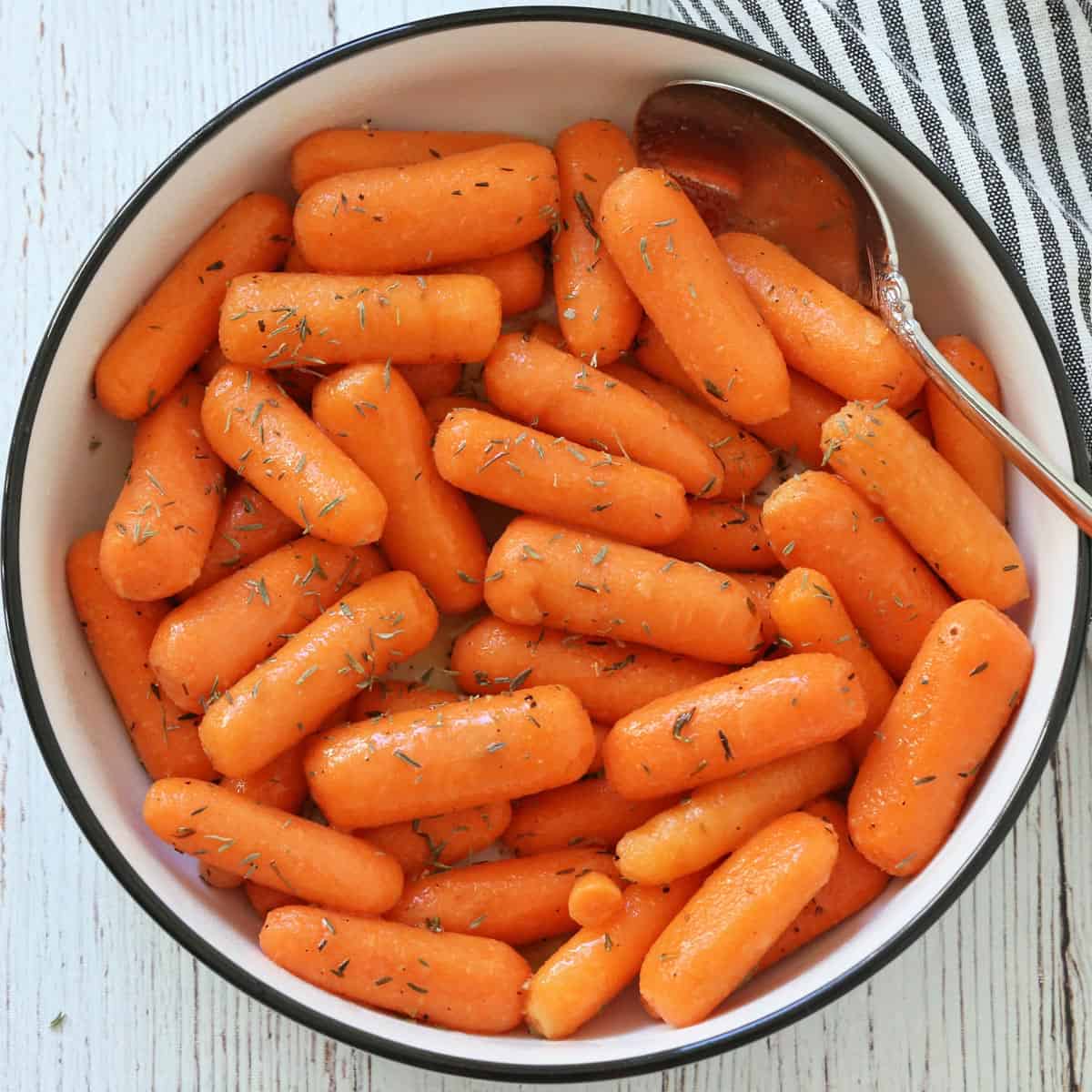 Glazed baby carrots in a bowl.