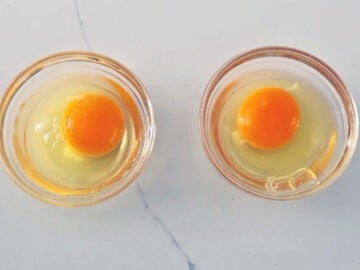 The eggs were cracked into two small bowls.