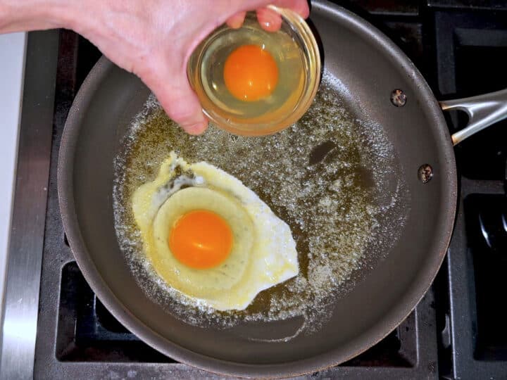 Adding the eggs to the skillet.