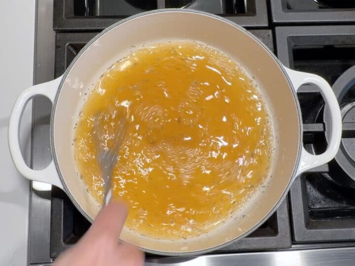 Whisking broth and spices.