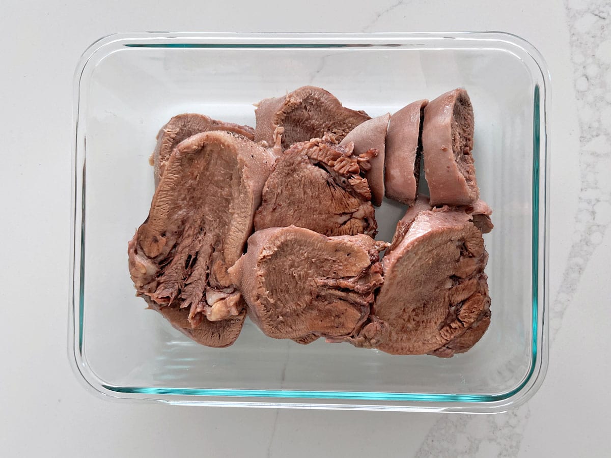 Beef tongue leftovers in a glass container.