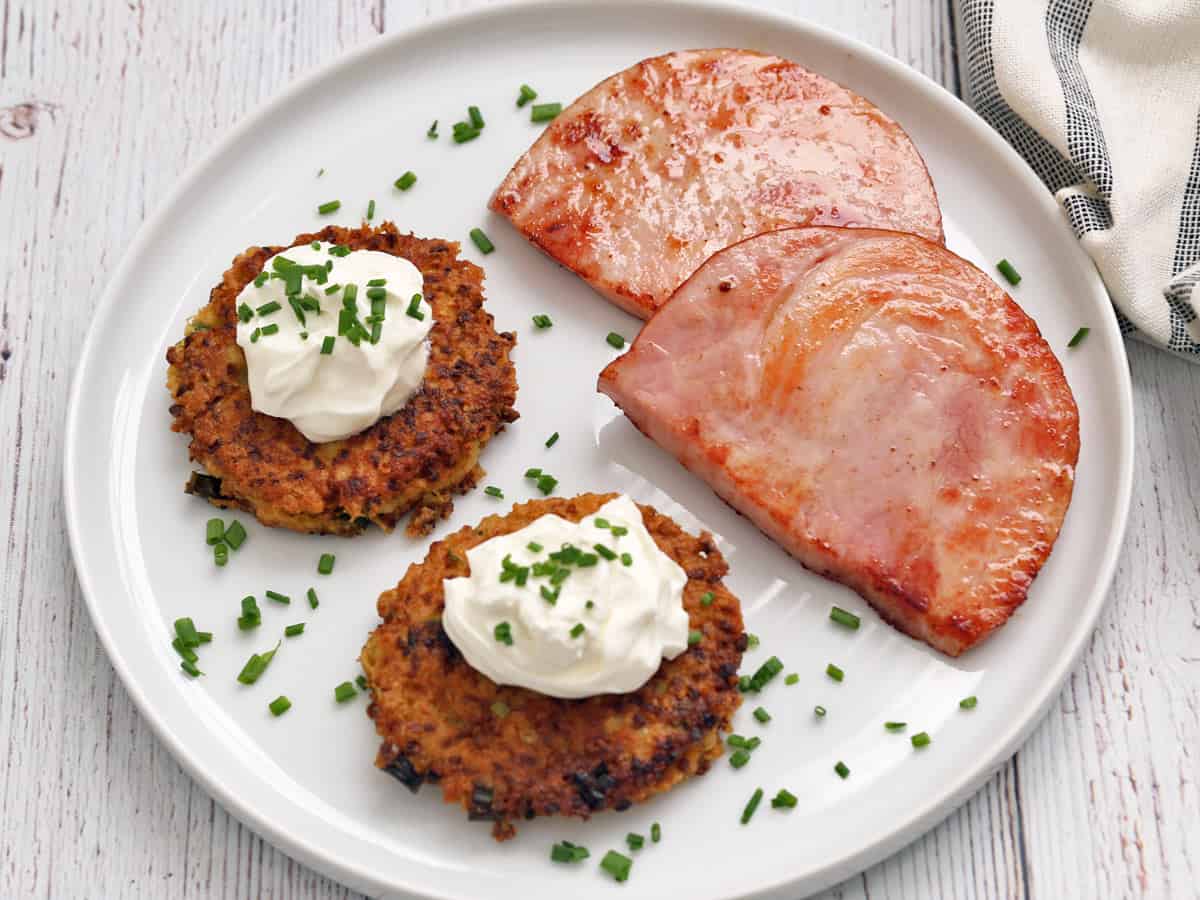 Cauliflower fritters are served with ham steak.
