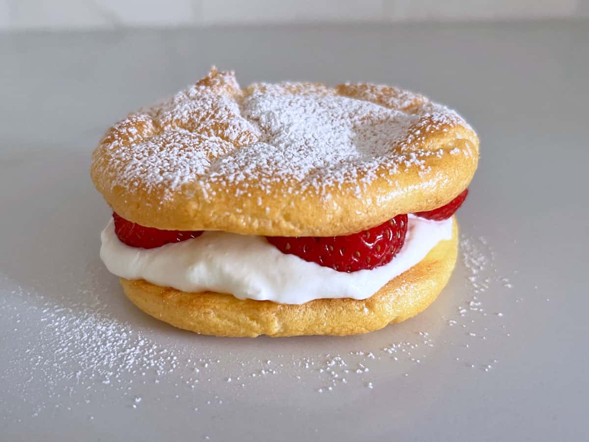Cloud bread is used as dessert with whipped cream and strawberries.