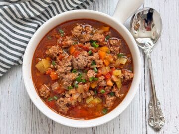 The soup is served with a spoon.