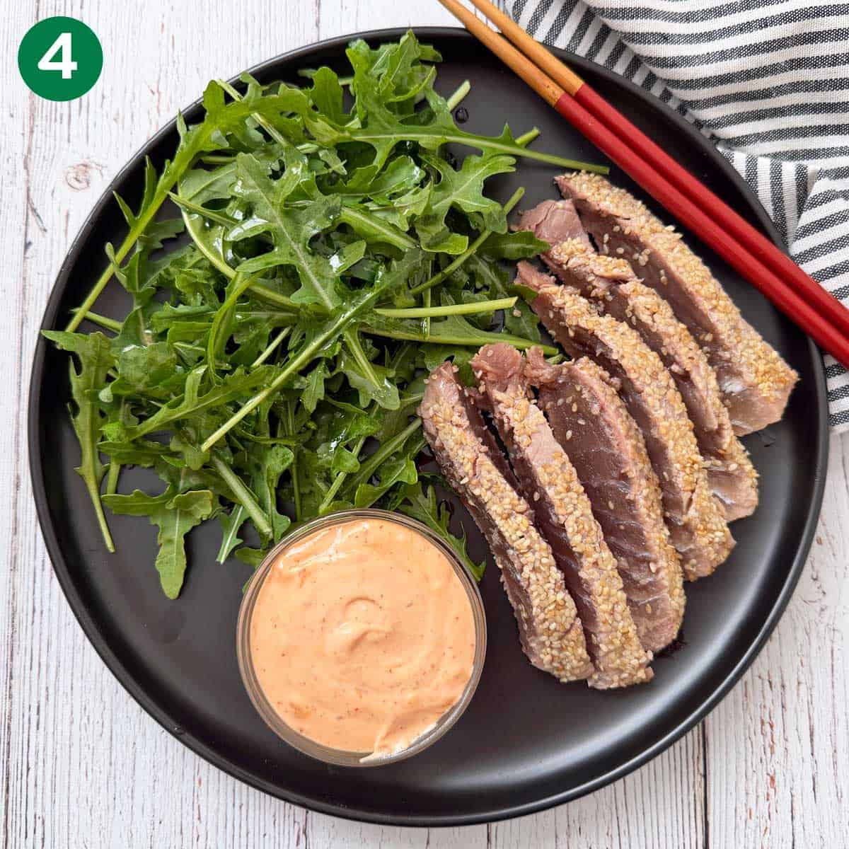 Sesame-crusted tuna steak is served.