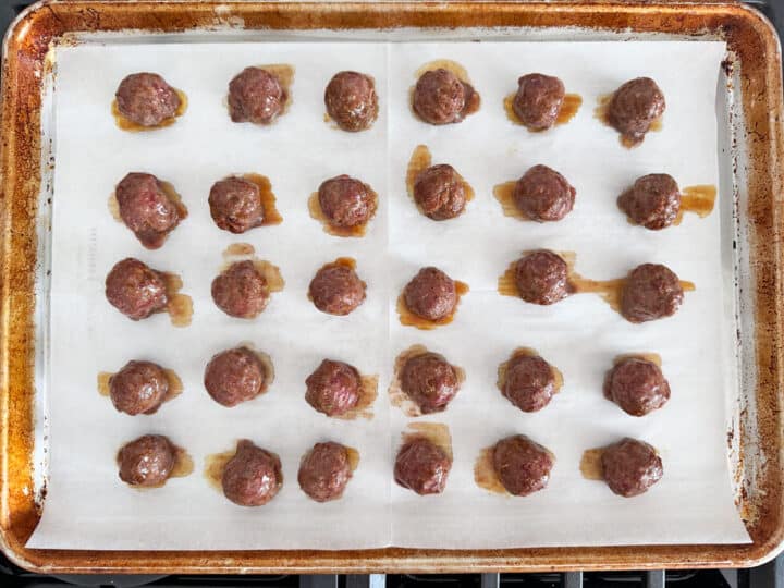 Cocktail meatballs on a baking sheet.