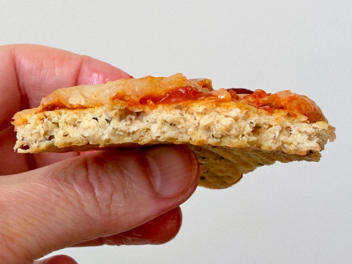 Showing the texture of a canned chicken pizza crust.