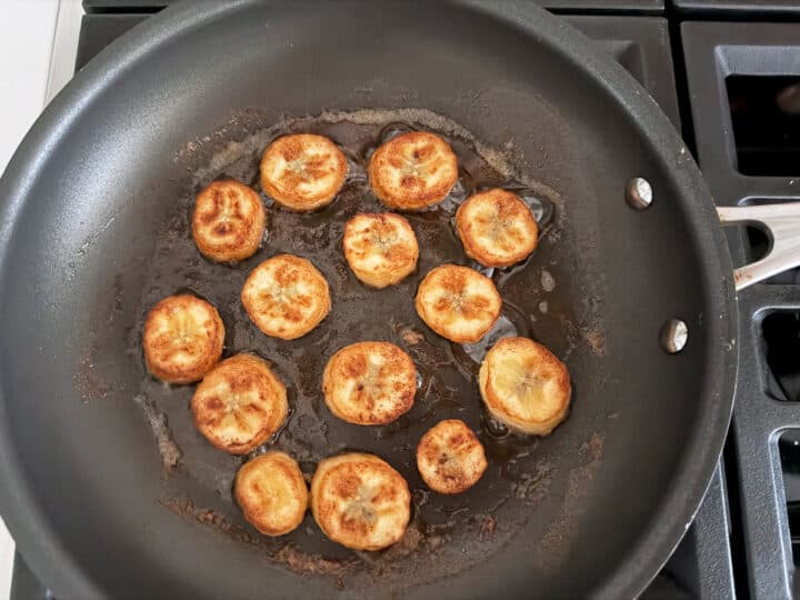 Banana slices are fried in a nonstick skillet.