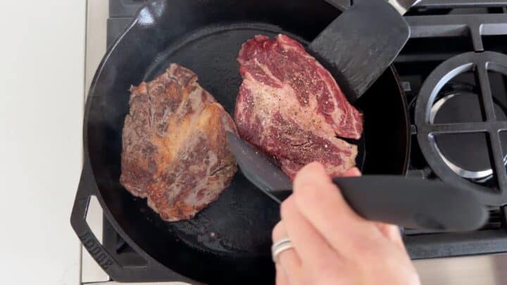 Flipping the steaks.