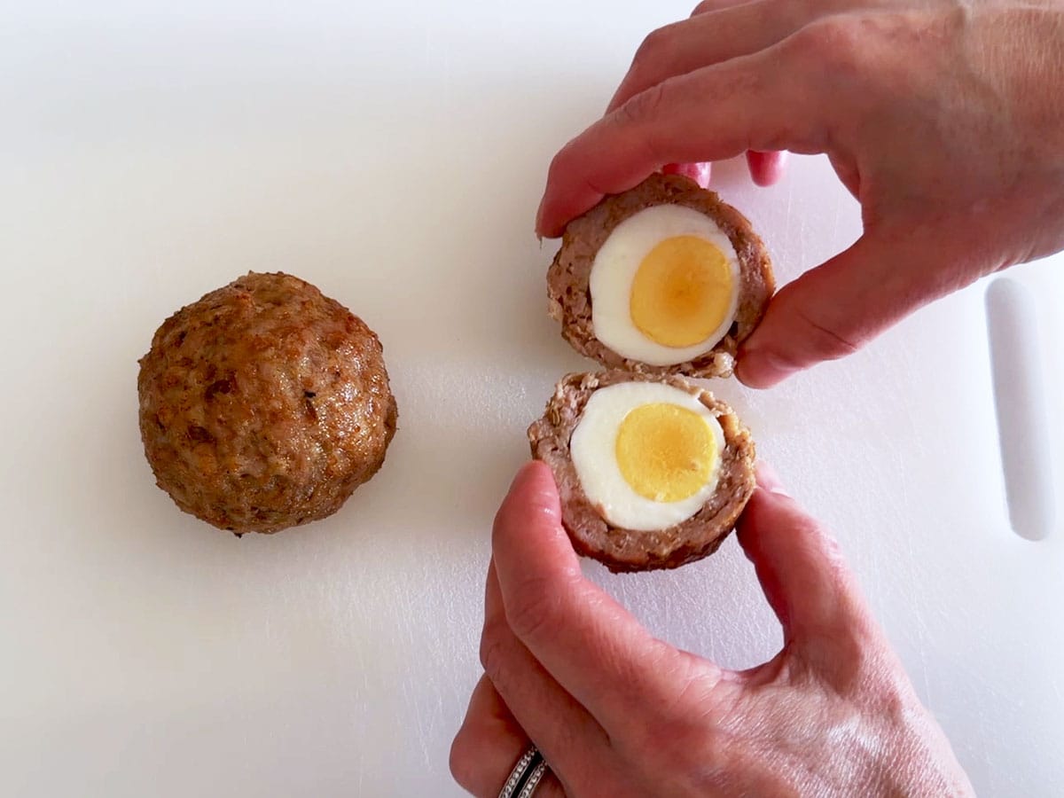 Cutting a Scotch egg in half.