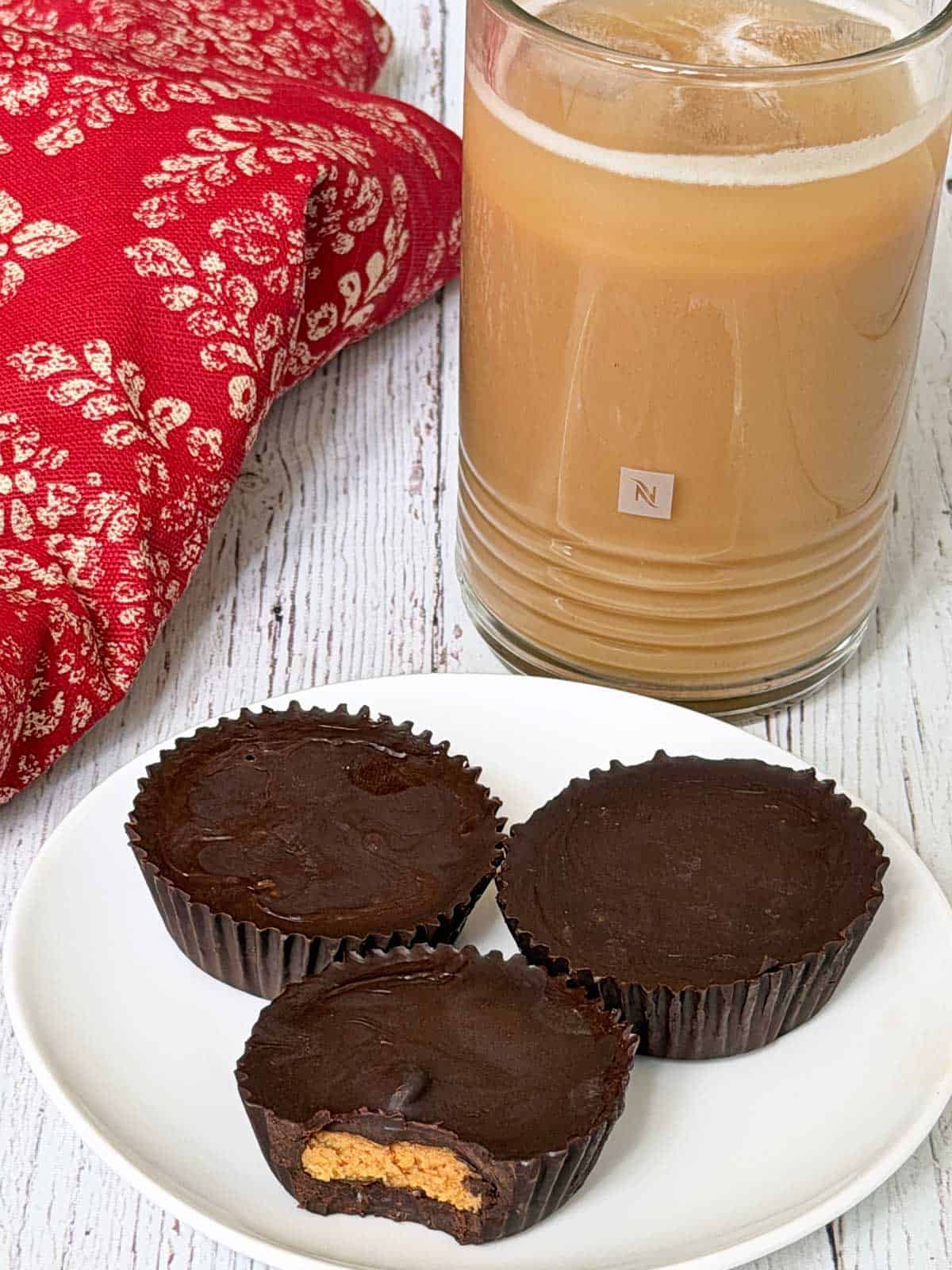 Peanut butter cups are served with iced coffee.